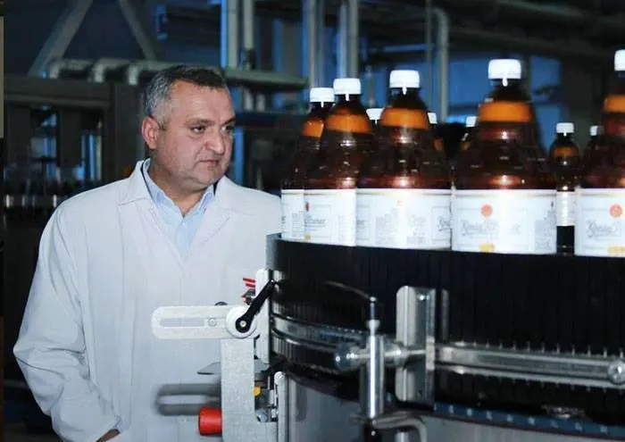 Tsezar Chocheli beside a bottling line