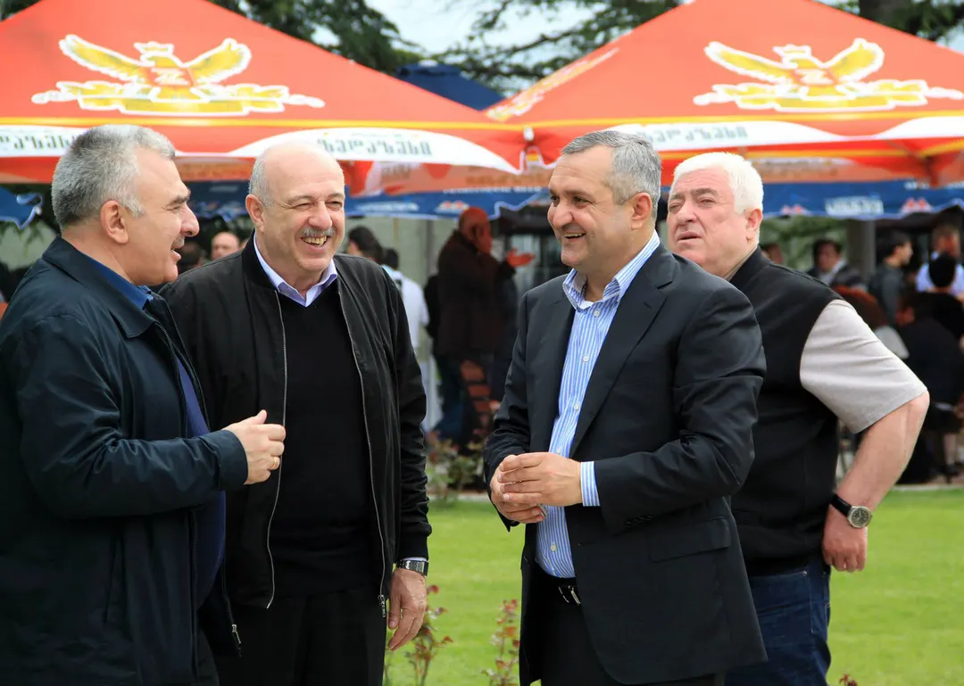 Tsezar Chocheli talking with guests at an outdoor event